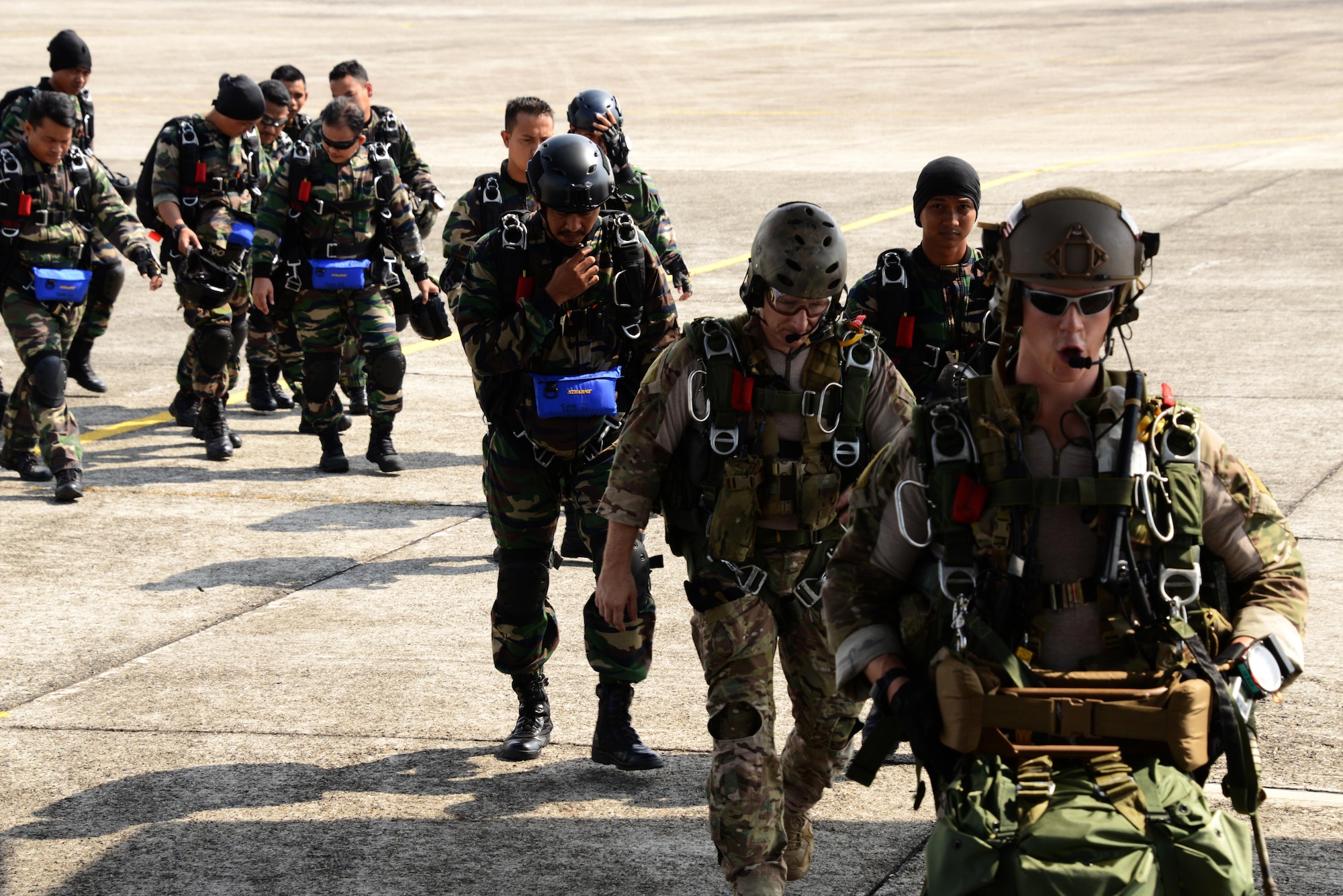 Special Tactics Airmen from the 320th Special Tactics Squadron and the 22nd Special Tactics Squadron, board an MC-130J Commando II with Royal Malaysian Air Force Pasukan Khas Udara in Kuantan, Malaysia, June 8, 2015.  The high-altitude low-opening jumps were conducted as part of Exercise Teak Mint, a multinational and bilateral exercise between the Royal Malaysian Air Force and the U.S. Air Force.  (U.S. Air Force photo by Tech. Sgt. Kristine Dreyer)  