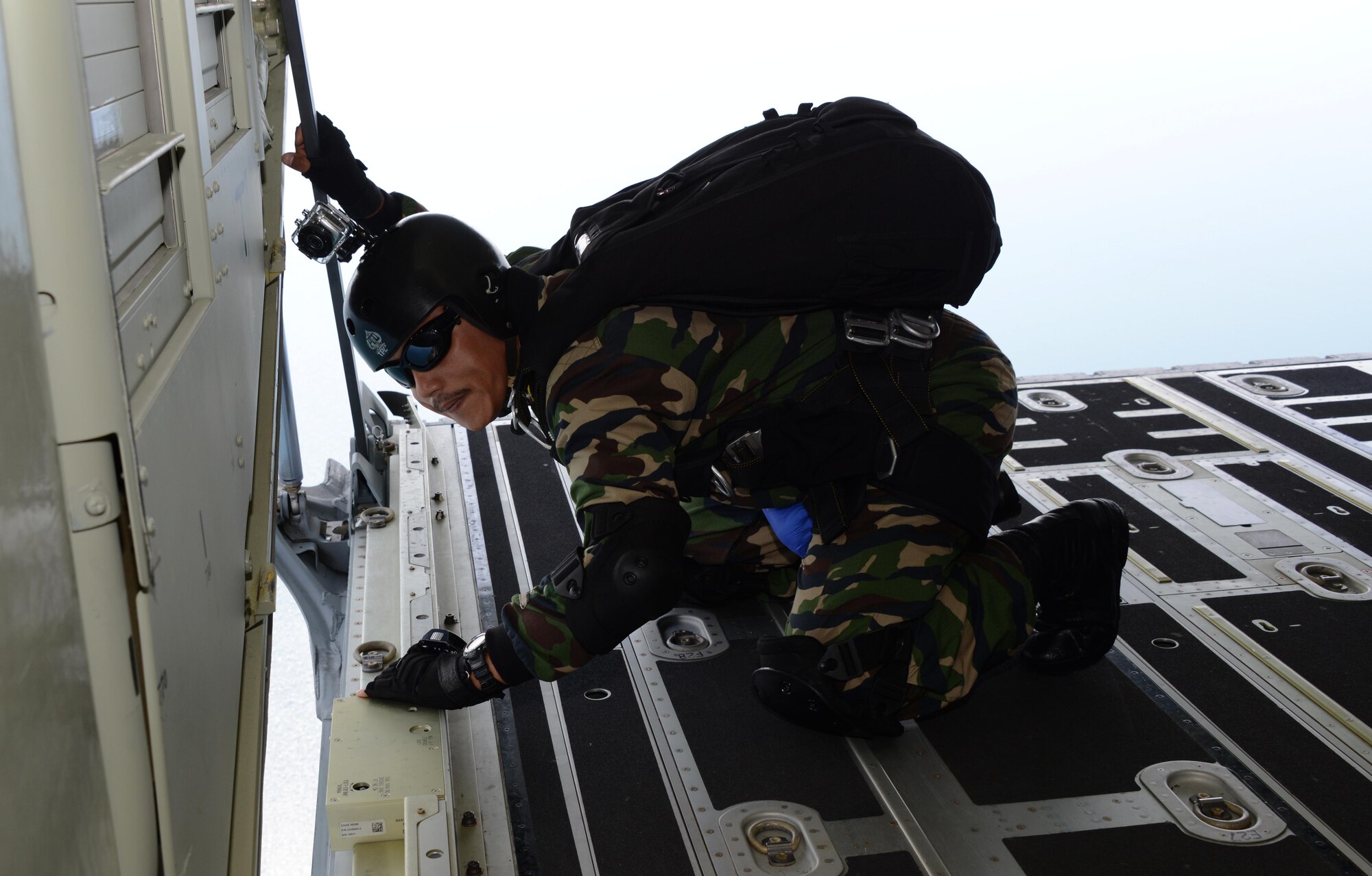 A member from the Royal Malaysian Air Force Pasukan Khas Udara locates the drop zone from an MC-130J Commando II near Kuantan, Malaysia, June 8, 2015.  The high-altitude low-opening jumps were conducted as part of Exercise Teak Mint, a multinational and bilateral exercise between the Royal Malaysian Air Force and the U.S. Air Force.  (U.S. Air Force photo by Tech. Sgt. Kristine Dreyer)  