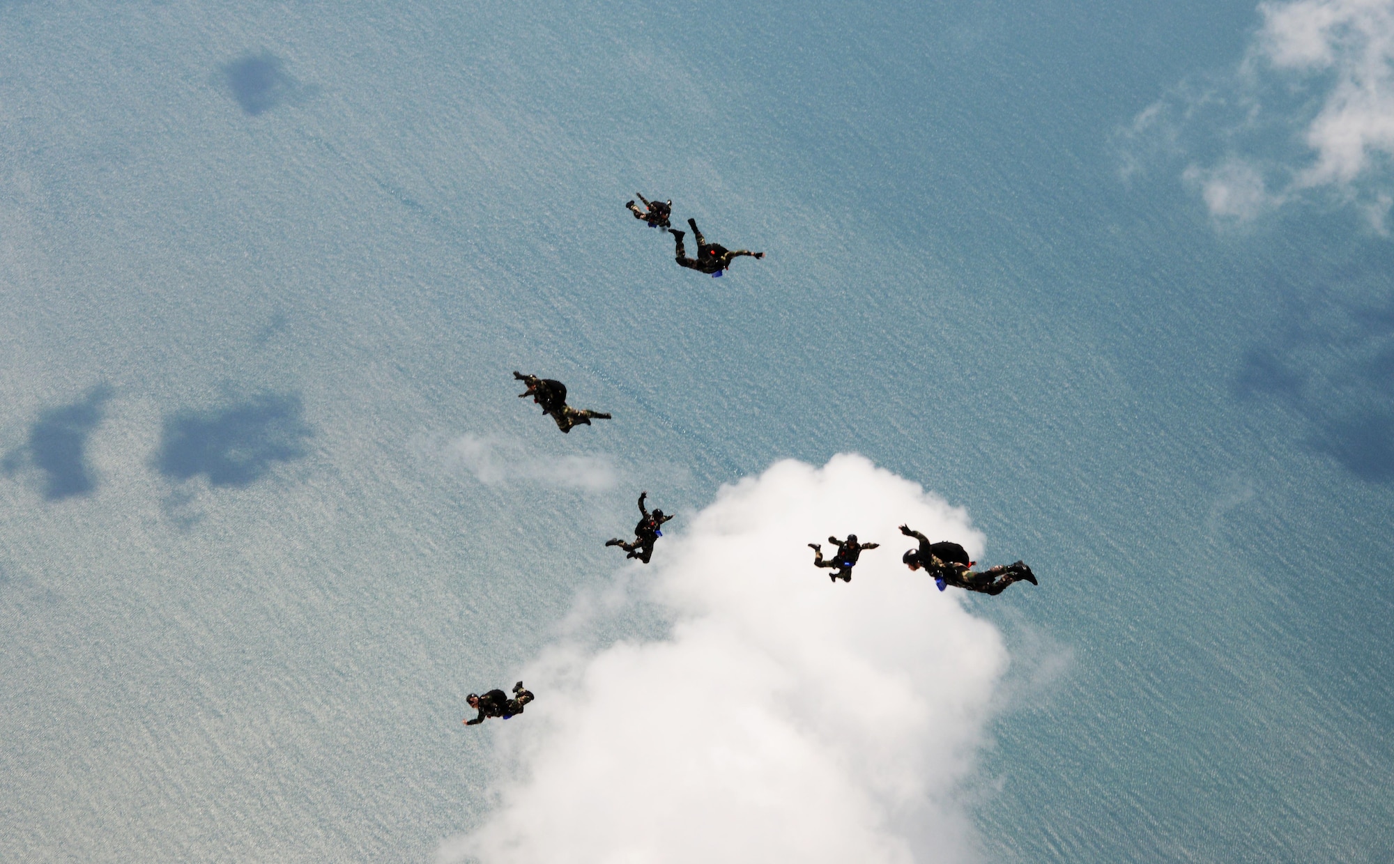 Members from the Royal Malaysian Air Force Pasukan Khas Udara jump from an MC-130J Commando II near Kuantan, Malaysia, June 8, 2015.  The high-altitude low-opening jumps were conducted as part of Exercise Teak Mint, a multinational and bilateral exercise between the Royal Malaysian Air Force and the U.S. Air Force.  (U.S. Air Force photo by Tech. Sgt. Kristine Dreyer)  