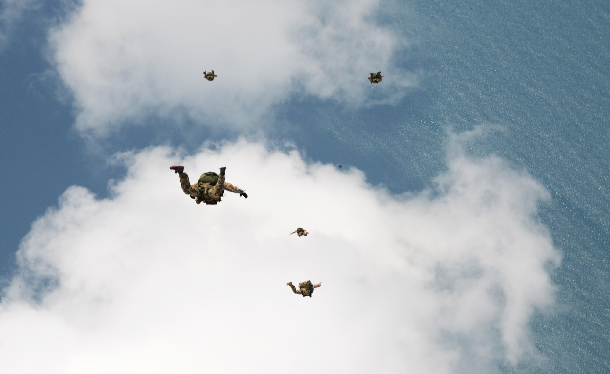 Special Tactics Airmen from the 320th Special Tactics Squadron and the 22nd Special Tactics Squadron jump from an MC-130J Commando II near Kuantan, Malaysia, June 8, 2015.  The high-altitude low-opening jumps were conducted as part of Exercise Teak Mint, a multinational and bilateral exercise between the Royal Malaysian Air Force and the U.S. Air Force.  (U.S. Air Force photo by Tech. Sgt. Kristine Dreyer)  