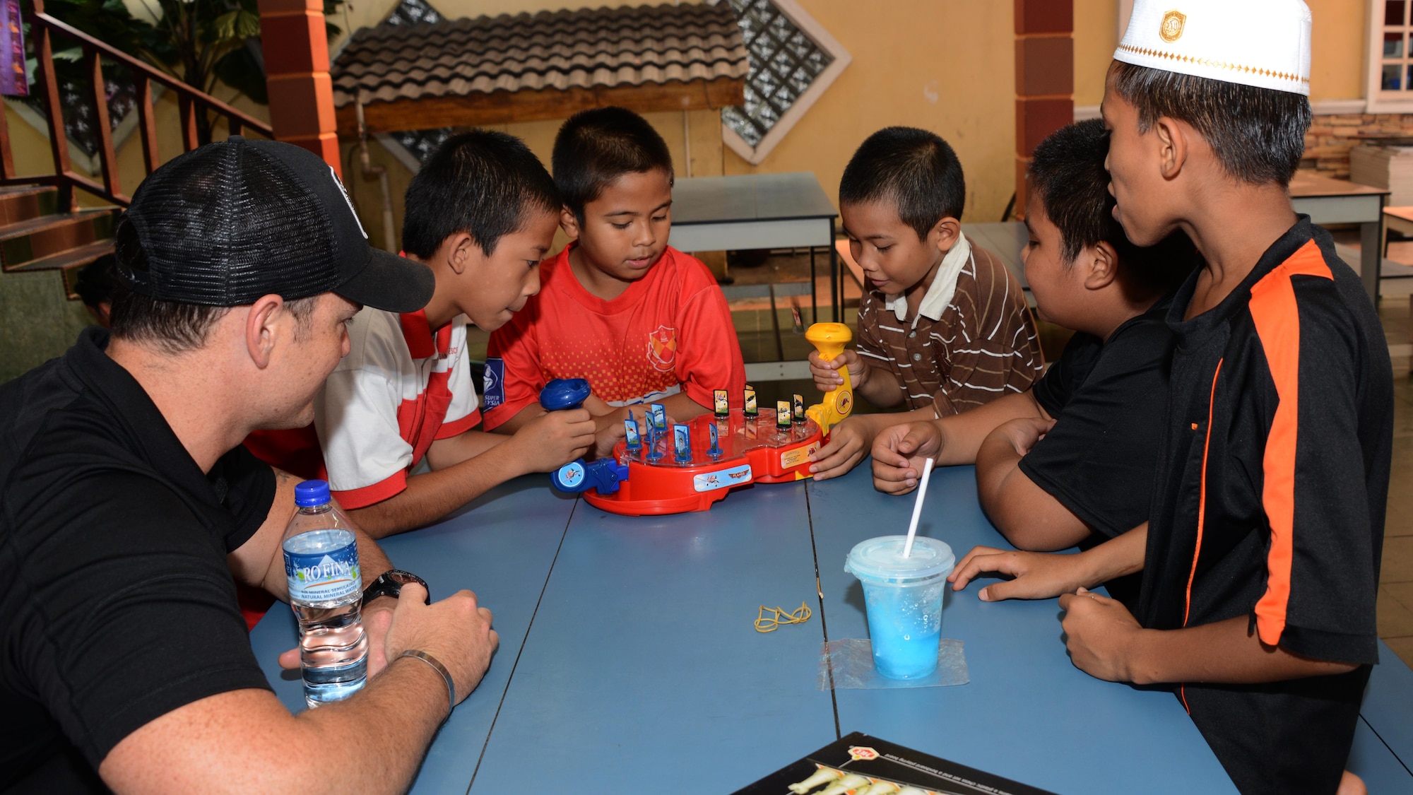 U.S. Air Force Capt. Forrest Underwood, a pilot from the 17th Special Operations Squadron, plays games with boys from the Rumah Kasih Hormoni Orphanage near Kuala Lumpur, Malaysia, June 6, 2015.  As part of Exercise Teak Mint, members from the RMAF, U.S. Air Force came together to help with repairs around the orphanage and donated more than  $1,000 in clothes, games and sports equipment.  (U.S. Air Force photo by Tech. Sgt. Kristine Dreyer)