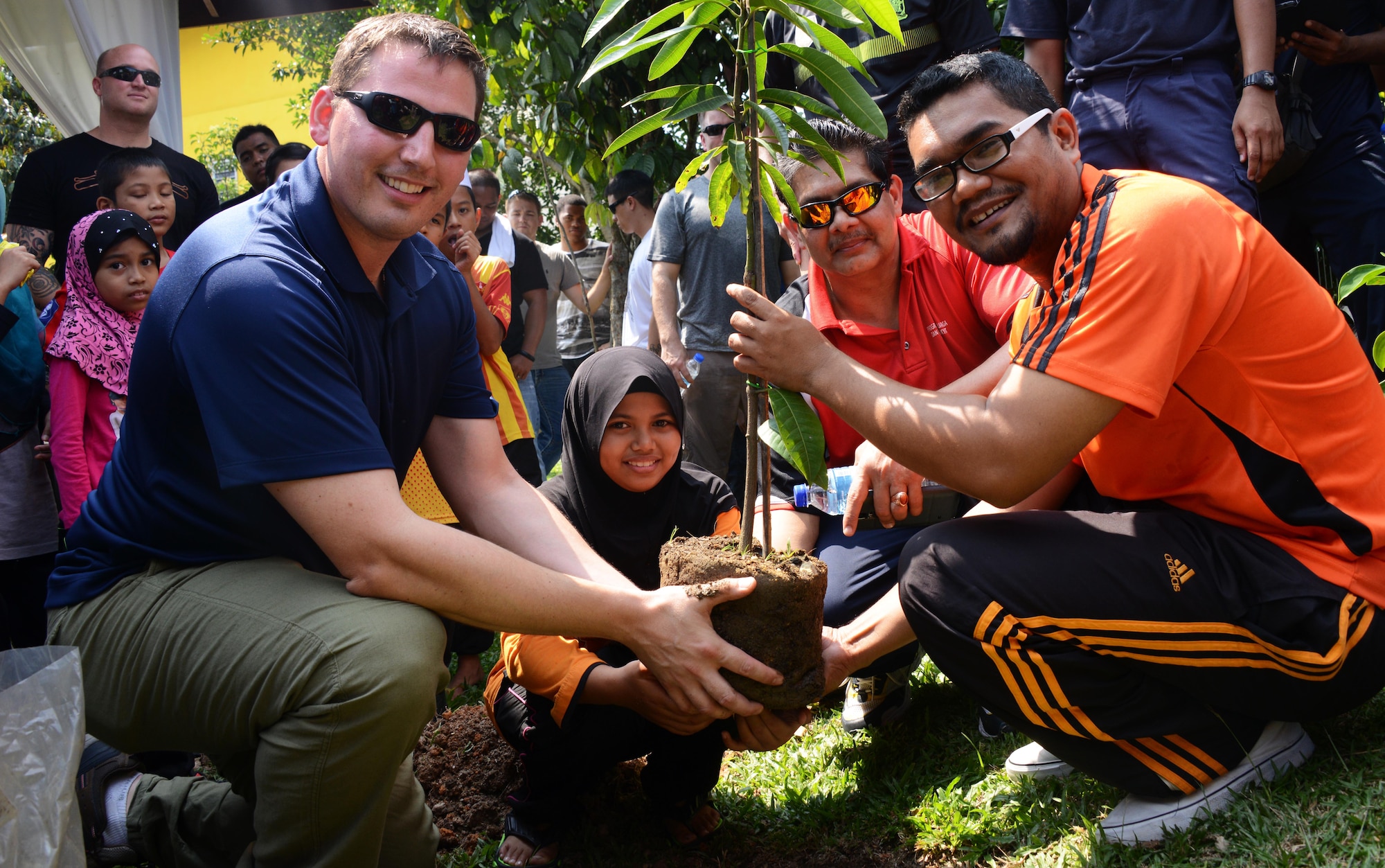 A member from the 353rd Special Operations Group and the Royal Malaysian Air Force play soccer with the children at the Rumah Kasih Hormoni Orphanage near Kuala Lumpur, Malaysia, June 6, 2015.  As part of Exercise Teak Mint, members from the RMAF, U.S. Air Force came together to help with repairs around the orphanage and donated more than $1,000 in clothes, games and sports equipment.  (U.S. Air Force photo by Tech. Sgt. Kristine Dreyer)