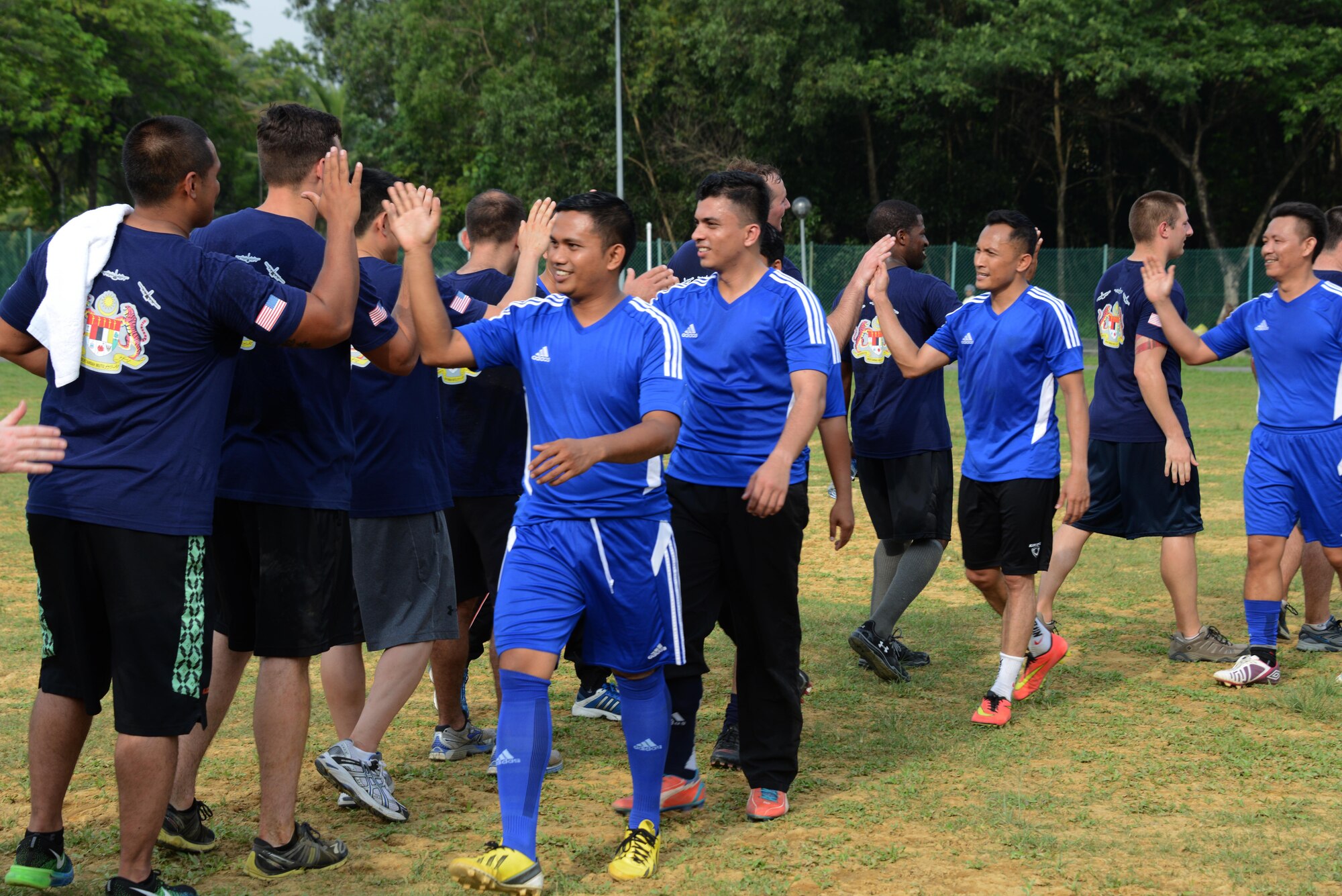 The U.S. Air Force team comprised of members from the 353rd Special Operations Group and the 36th Airlift Squadron congratulates the Royal Malaysian Air Force team after losing a friendly soccer match 4-3 June 9, 201 near Subang Air Base, Malaysia.  The match was played as part of Teak Mint, a multinational and bilateral training exercise held to improve interoperability to between the U.S. Air Force and the Royal Malaysian Air Force.  (U.S. Air Force photo by Tech. Sgt. Kristine Dreyer)