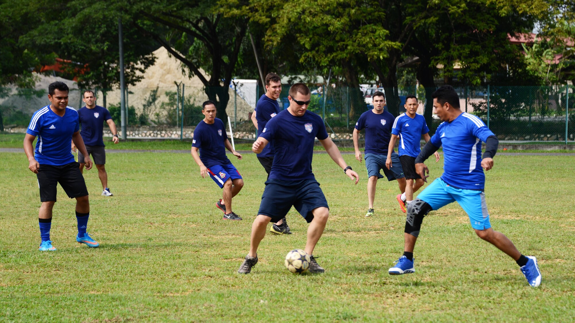 U.S. Air Force Capt. John Hitsos, a combat systems operator at the 17th Special Operations Squadron, attempts to move past a Royal Malaysian Air Force player from the 20th Squadron during a friendly soccer match.  The U.S. Air Force team, comprised of members from the 353rd Special Operations Group along with the 36th Airlift Squadron, played the Royal Malaysian Air Force June 9, 201 near Subang Air Base, Malaysia.  The match was played as part of Teak Mint, a multinational and bilateral training exercise held to improve interoperability to between the U.S. Air Force and the Royal Malaysian Air Force.  The Royal Malaysian Air Force team won the match 4-3.  (U.S. Air Force photo by Tech. Sgt. Kristine Dreyer)