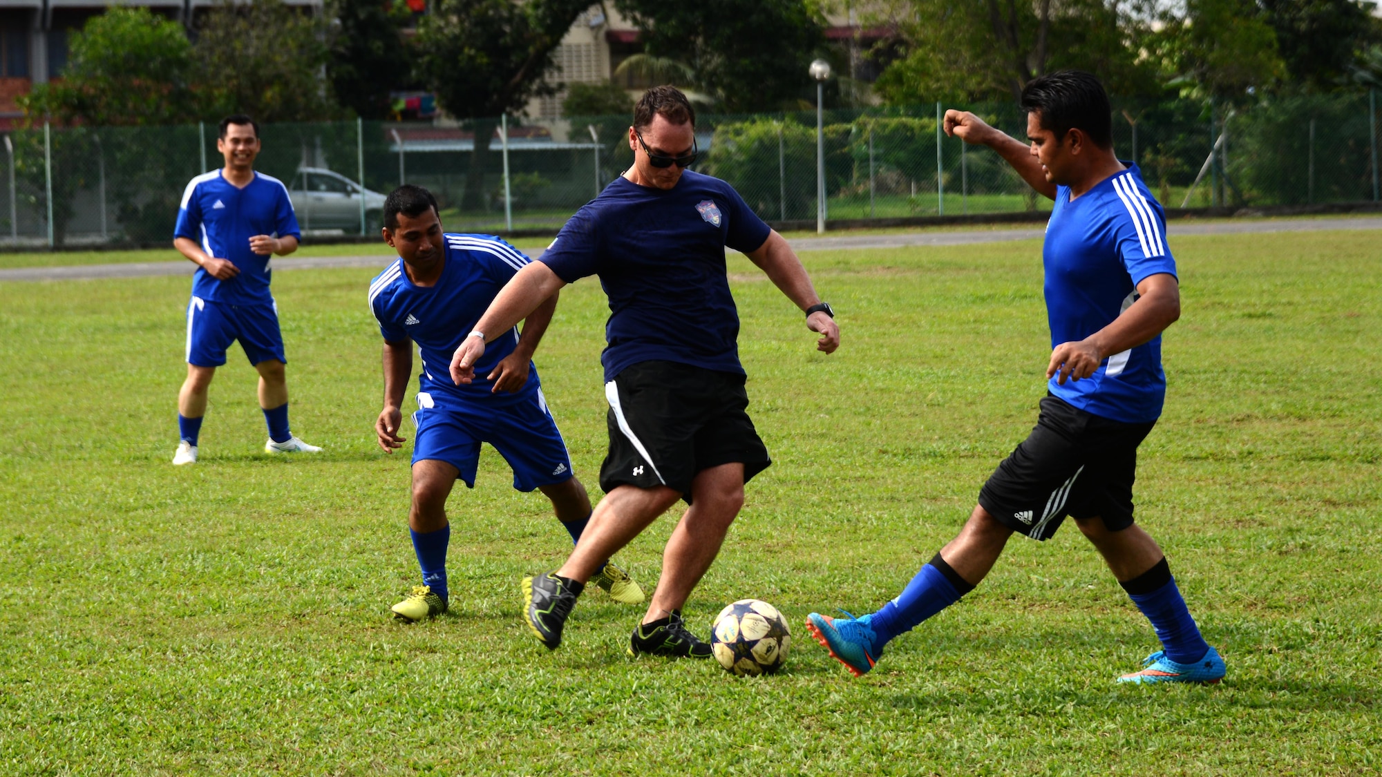 U.S. Air Force Capt. Forrest Underwood, a pilot at the 17th Special Operations Squadron, attempts to stop a Royal Malaysian Air Force player from the 20th Squadron during a friendly soccer match between the U.S. Air Force and the Royal Malaysian Air Force June 9, 2015 near Subang Air Base, Malaysia.  The match was played as part of Teak Mint, a multinational and bilateral training exercise held to improve interoperability to between the U.S. Air Force and the Royal Malaysian Air Force.  The Royal Malaysian Air Force team won the match 4-3.    (U.S. Air Force photo by Tech. Sgt. Kristine Dreyer)