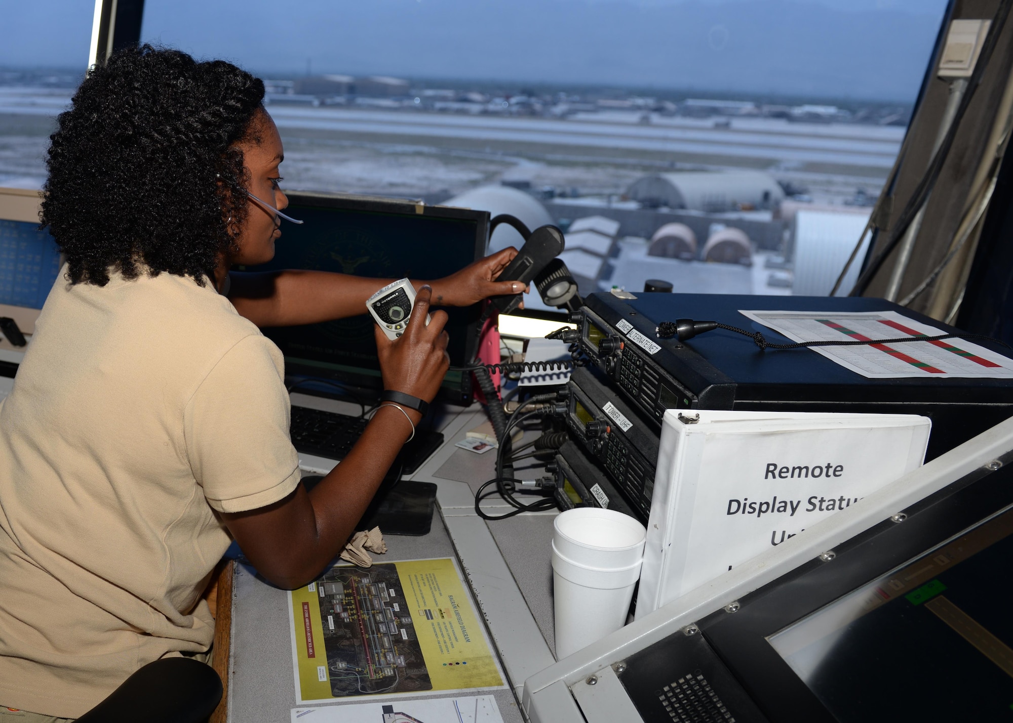 Madonna Moffatte sends out information to air crews while working in the air traffic control tower June 17, 2015, at Bagram Airfield, Afghanistan.  Moffatte is a part of the Midwest Air Traffic Control team that has managed Bagram’s air traffic since 2003. (U.S. Air Force photo by Senior Airman Cierra Presentado/Released)