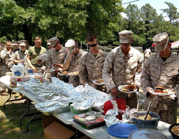 13 Jun 2015 – Weapons Training Battalion Marines get fresh BBQ at the conclusion of the “Call of Duty” family day aboard Stone Bay.  WTBN family and friends participated in martial arts, physical fitness, indoor simulated marksmanship trainer (ISMT), capture the flag, logic problem, weapons static display and live fire rifle and pistol events.  The day culminated with a potluck and plaque presentation for the high pistol shooter, high rifle shooter, and fastest fitness course time.