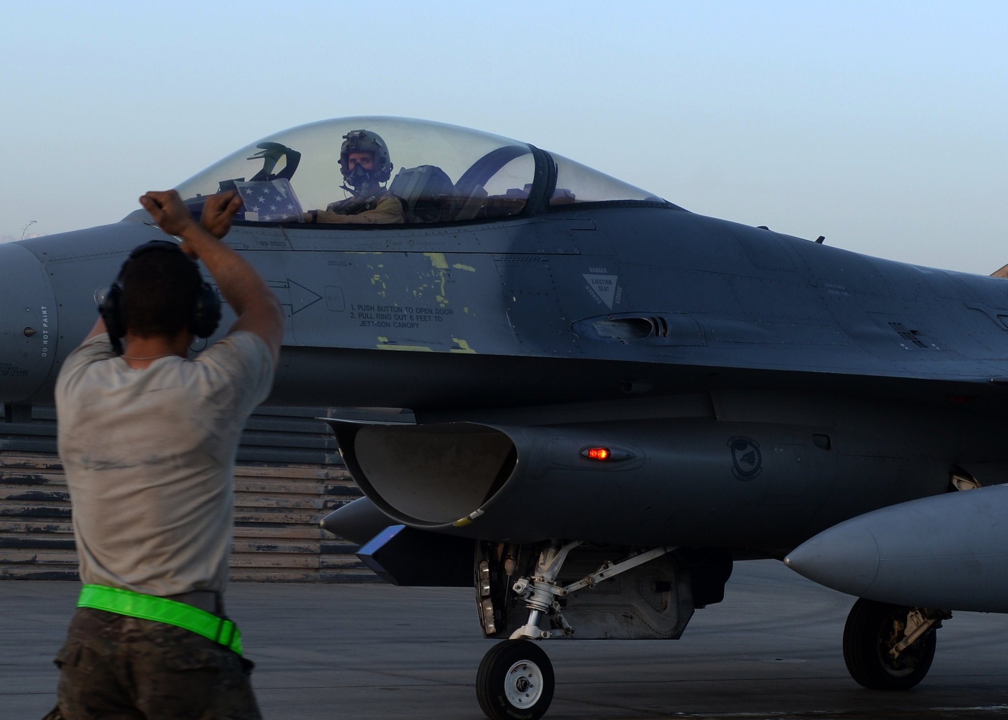 U.S. Air Force Capt. Dakota Olsen, 555th Expeditionary Fighter Squadron F-16 pilot, waits for a crew chiefs command to move before taking off June 17, 2015, at Bagram Airfield, Afghanistan. Olsen’s job is to provide close air support and armed over watch for military personnel in Afghanistan. He flies various sorties and missions throughout the country on a daily basis providing airpower to ensure a safe and secure environment for personnel at BAF. (U.S. Air Force photo by Senior Airman Cierra Presentado/Released)