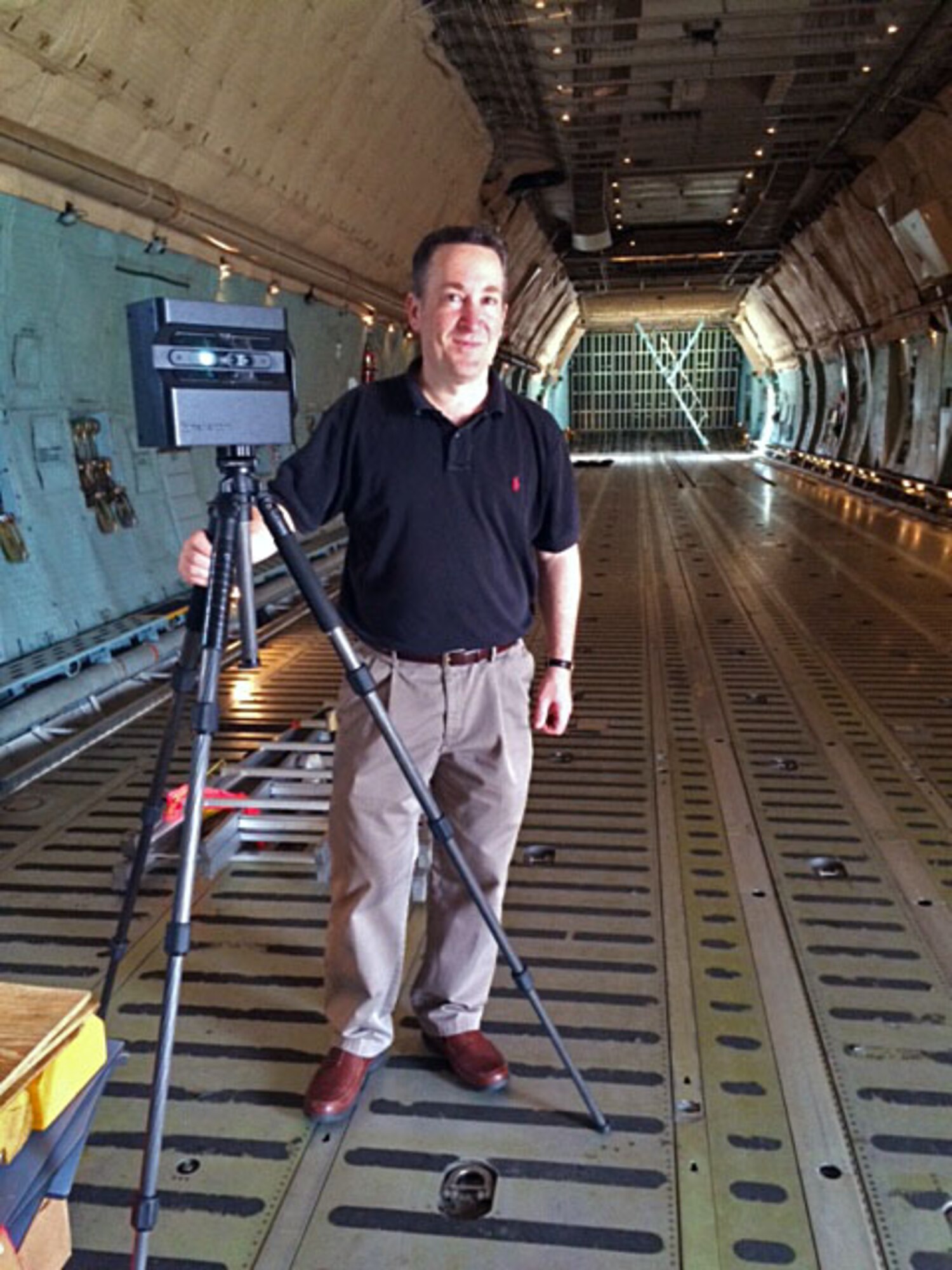 Tony Healy poses with his 3-D capable camera in the cargo bay of a Westover C-5. 
