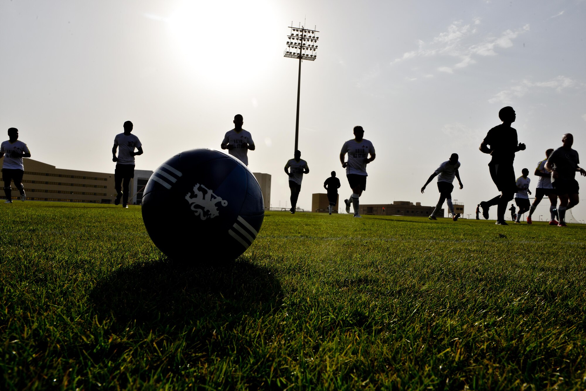 Members of the Al Udeid All-Stars conduct warm up exercises prior to a soccer match against Qatari military members in celebration of the 240th U.S.  Army birthday June 14, 2015 at Al Udeid Air Base, Qatar. AUAB All-Stars planned a soccer match to help strengthen the partnership between the U.S. and Qatari military and build friendships between service members. (U.S. Air Force photo/Staff Sgt. Alexandre Montes)