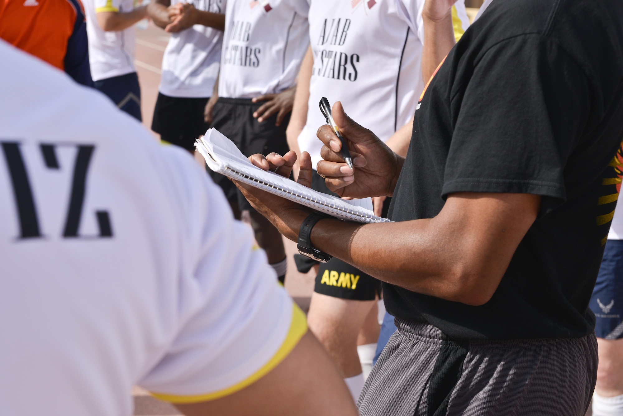 Members of the Al Udeid All-Stars go over a game plan at half-time during a soccer match against Qatari military members in celebration of the 240th U.S.  Army birthday June 14, 2015 at Al Udeid Air Base, Qatar. AUAB All-Stars planned a soccer match to help strengthen the partnership between the U.S. and Qatari military and build friendships between service members. (U.S. Air Force photo/Staff Sgt. Alexandre Montes)