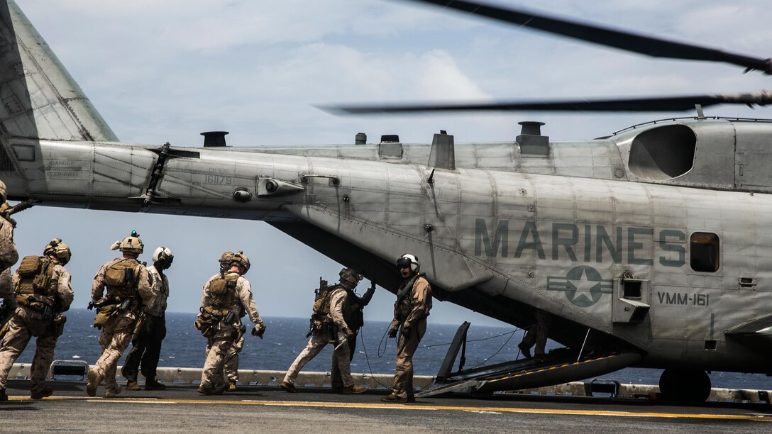 U.S. Marines with the 15th Marine Expeditionary Unit’s Maritime Raid Force load into a CH-53E Super Stallion aboard the USS Essex (LHD 2) at sea in the Indian Ocean, June 17, 2015. These Marines were practicing fast-roping out of the helicopter onto a moving vessel; an essential skill for the MRF during visit, board, search, and seizure missions. 