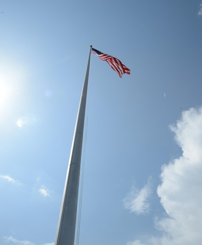 Colors fly in front of Marine Corps Logistics Base Albany’s Coffman Hall, June 17, after a pulley mechanism is repaired.
