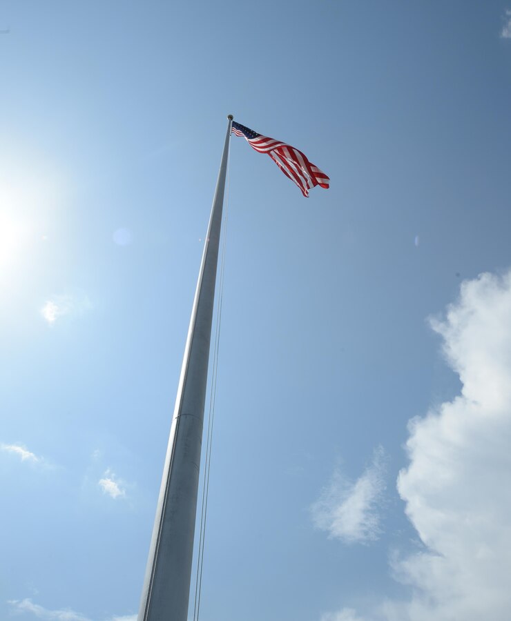 Colors fly in front of Marine Corps Logistics Base Albany’s Coffman Hall, June 17, after a pulley mechanism is repaired.