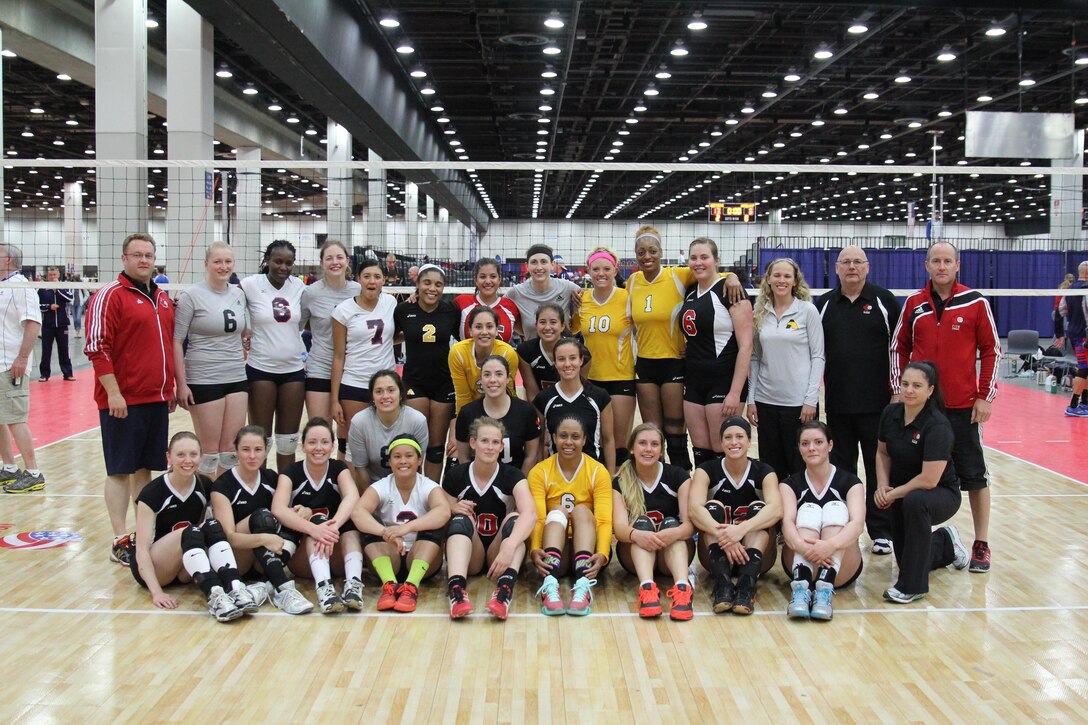 Service members from the Army, Navy and Air Force women's volleyball teams pose with Team Canada after a friendly international Conseil International du Sport Militaire (CISM) exhibition match during the 2015 Armed Forces Volleyball Championship held in conjunction with the USA Volleyball National Championship at the COBO Center in Detroit, Mich. 22-24.