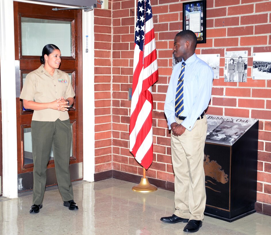 Jawaun Stanley, a Lee County High School graduate, listens as Capt. Rene Barber, project manager, Marine Corps Systems Command-Albany, congratulates him on his oath of enlistment as a midshipman in the Navy Reserves. Stanley recited the oath in front of Marine Corps Logistics Base Albany's Coffman Hall, June 17, while his parents, Marines, Navy recruiters and civilian-Marines watched. Stanley will attend the Naval Academy Preparatory School in Rhode Island before attending the U.S. Naval Academy in Annapolis, Md.