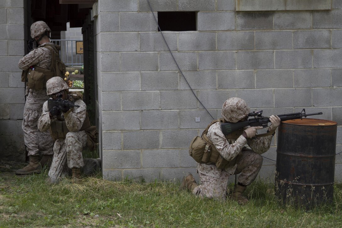 Marines from Company B post security during training at Marine Corps Base Quantico’s military operations in urban terrain, training facility. On June 17, 2015 more than 100 Marines from B Co., Marine Barracks Washington, D.C., traveled to the Quantico, Va. MOUT town to refine their individual actions in an urban environment. “The training is focused on 1000-level training and readiness tasks [to include] making lower level entry into a compound and room clearing using proper techniques and procedures,” said Capt. David Moon, 3rd platoon commander, B. Co, Marine Barracks Washington, D.C. “With the complexity of today’s operating environment and the growth in large urban hubs this is the focus for the future. Although there is still importance on conventional warfare, a lot of the wars are fought in the urban environment.” (U.S. Marine Corps photo by Cpl. Skye Davis/Released)