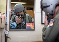 Col. John Menozzi, the 71st Flying Training Wing vice commander, conducts a final check of his life support gear at Vance Air Force Base, Oklahoma, June 11. Almost 23 years after he'd completed Joint Specialized Undergraduate Pilot Training at Vance, Menozzi completed his final flight as a military aviator. (U.S. Air Force photo by David Poe)