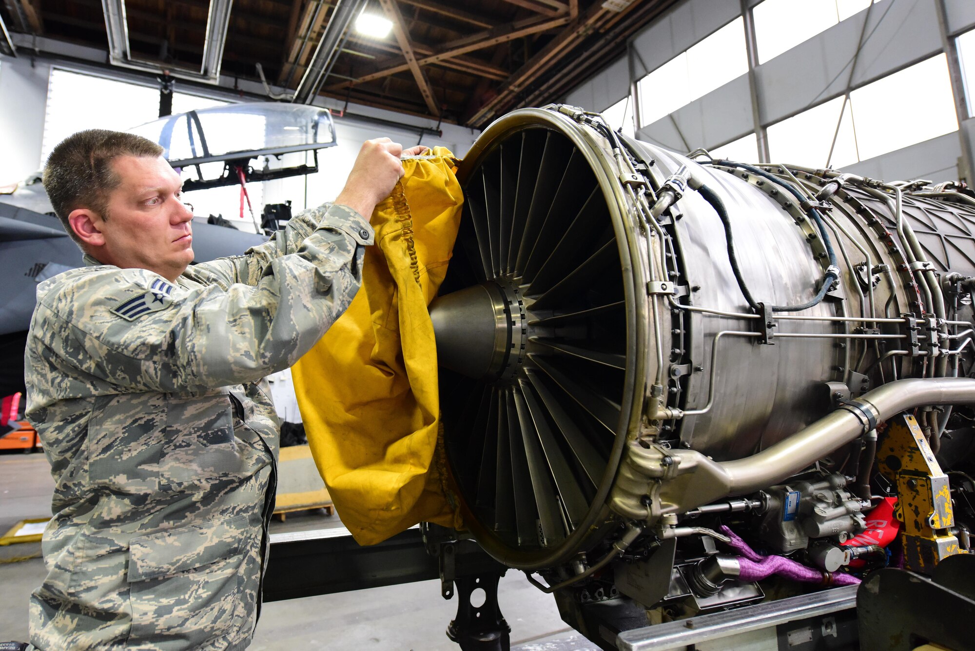 Senior Airman Travis Bearden, 414th Maintenance Squadron aerospace propulsion journeyman, removes a cover in preparation for a “-6” engine pre-installation inspection at Mountain Home Air Force Base, Idaho June 1. Bearden, temporarily assigned to the 391st Aircraft Maintenance Unit, is one of 10 reservists from Seymour Johnson Air Force Base, N.C., serving in an active duty capacity with the 366th Maintenance Group. (U.S. Air Force photo Staff Sgt. Lausanne Kinder)
