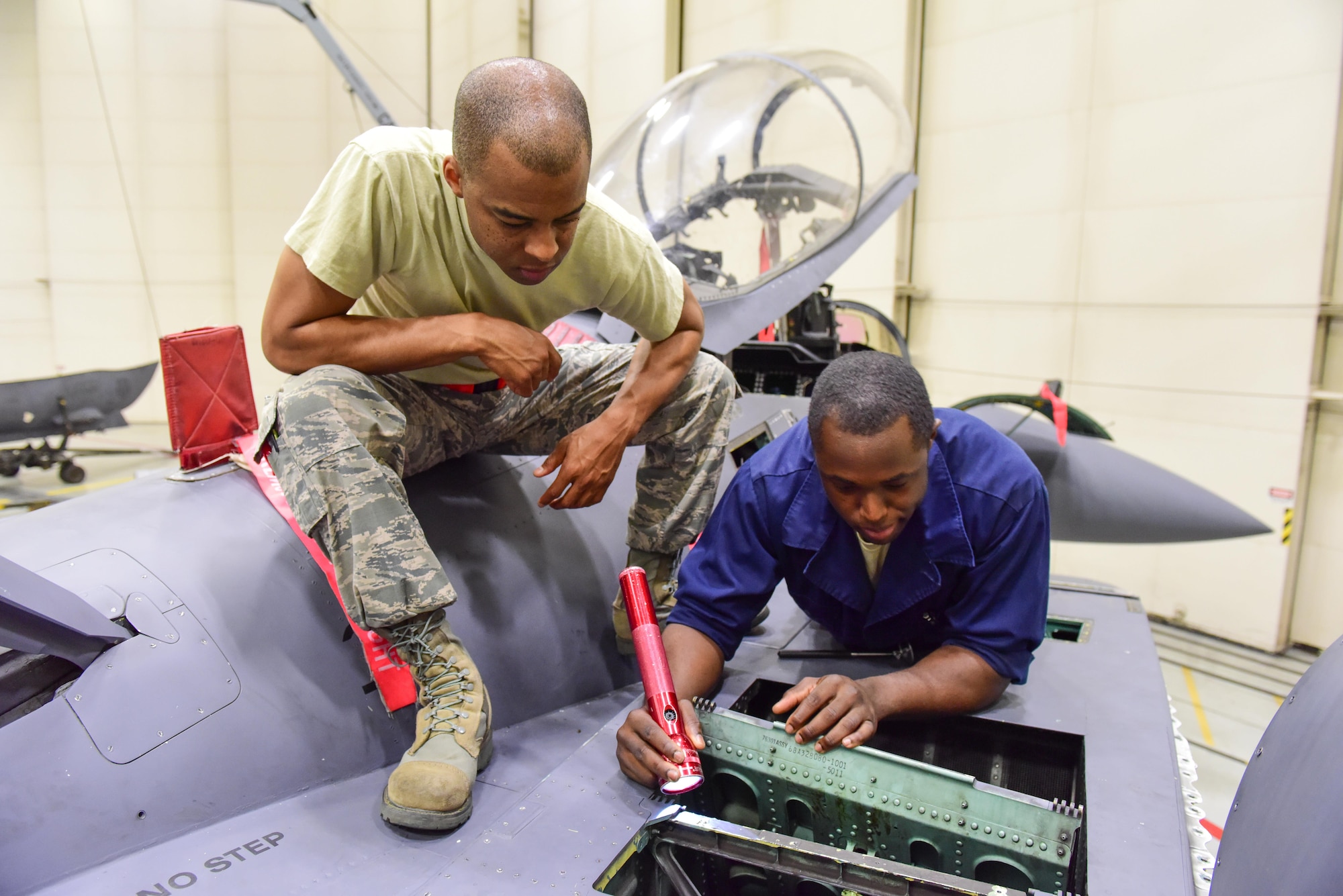 Staff Sgt. Stephen Young and Senior Airman Alexander Oakes, 414th Maintenance Squadron crew chiefs, inspect the inside of an intake surface on an F-15E Strike Eagle during a routine phase inspection at Mountain Home Air Force Base, Idaho June 1. An aircraft that has reached a certain number of flying hours must go through more in-depth inspections to ensure it maintains its flight safety status. Young and Oaks, temporarily assigned to the 366th Equipment Maintenance Squadron Phase, are two of 10 reservists from Seymour Johnson Air Force Base, N.C., serving in an active duty capacity with the 366th Maintenance Group. (U.S. Air Force photo Staff Sgt. Lausanne Kinder) 
