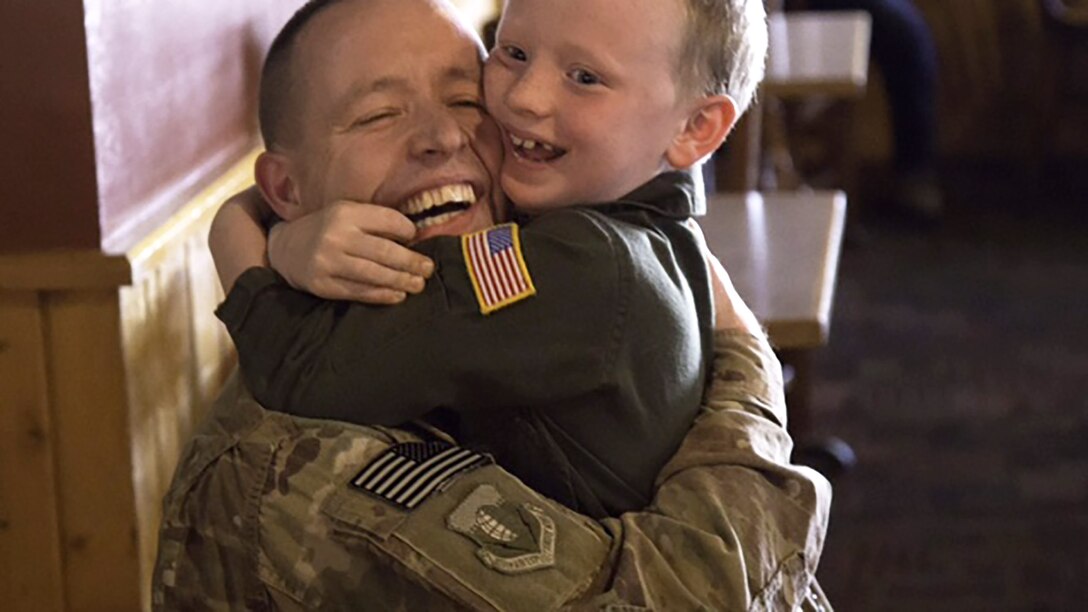 Chaplain (Capt.) Keith Manry greets his son, Benjamin, June 16, 2014, after returning from a deployment. Manry is assigned to the 341st Missile Wing at Malmstrom Air Force Base, Mont., and was recently awarded the Air Force Chaplain Corps Company Grade Officer Chaplain of the Year for 2014. (Courtesy photo)