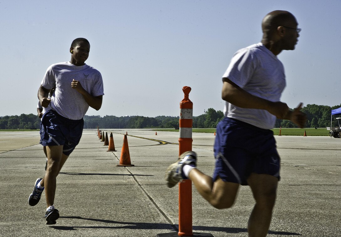 U.S. Air Force Tech. Sgt. Phillip Berry (right), 38th Aerial Port Squadron Port Dawg Challenge participant, leads his team as they race other Airmen competing in the Port Dawg Challenge at Dobbins Air Reserve Base, Ga., June 17, 2015. The Port Dawg Challenge was created to enhance and maintain the camaraderie, esprit de corps and prestige of aerial port Airmen while promoting professionalism, leadership, training and communication between "Port Dawgs." (U.S. Air Force photo by Senior Airman Josh Slavin/Released)