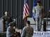 U.S. Air Force Maj. Gen. Stayce D. Harris, 22nd Air Force  commander, and the 94th Airlift Wing commander, U.S. Air Force Col. Brett Clark, watch a full-size bronze sculpture of a bulldog, the trophy for the 