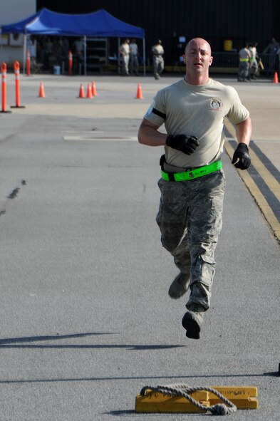 U.S. Air Force Staff Sgt. Brady Frasier, 71st Aerial Port Squadron, runs towards a set of chalks during the 25K Halverson driving and loading course portion of the Port Dawg Challenge at Dobbins Air Reserve Base, Ga., June 16, 2015. The Port Dawg Challenge was created to enhance and maintain the camaraderie, esprit de corps and prestige of aerial port Airmen while promoting professionalism, leadership, training and communication between "Port Dawgs." (U.S. Air Force photo by Tech. Sgt. Stephen D. Schester/Released)