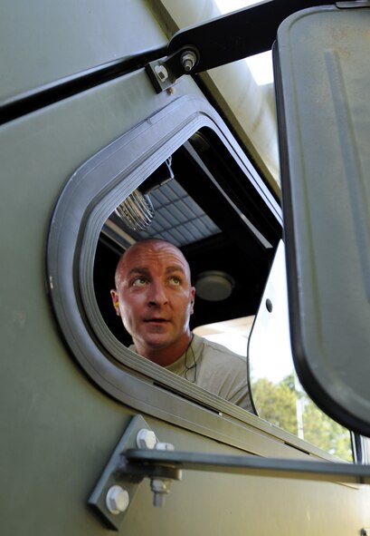 U.S. Air Force Staff Sgt. Brady Frasier, 71st Aerial Port Squadron, checks his side mirror as a driver during the 25K Halverson driving and loading course portion of the Port Dawg Challenge, Dobbins Air Reserve Base, Ga., June 16, 2015. The Port Dawg Challenge was created to enhance and maintain the camaraderie, esprit de corps and prestige of aerial port Airmen while promoting professionalism, leadership, training and communication between "Port Dawgs." (U.S. Air Force photo by Tech. Sgt. Stephen D. Schester/Released)