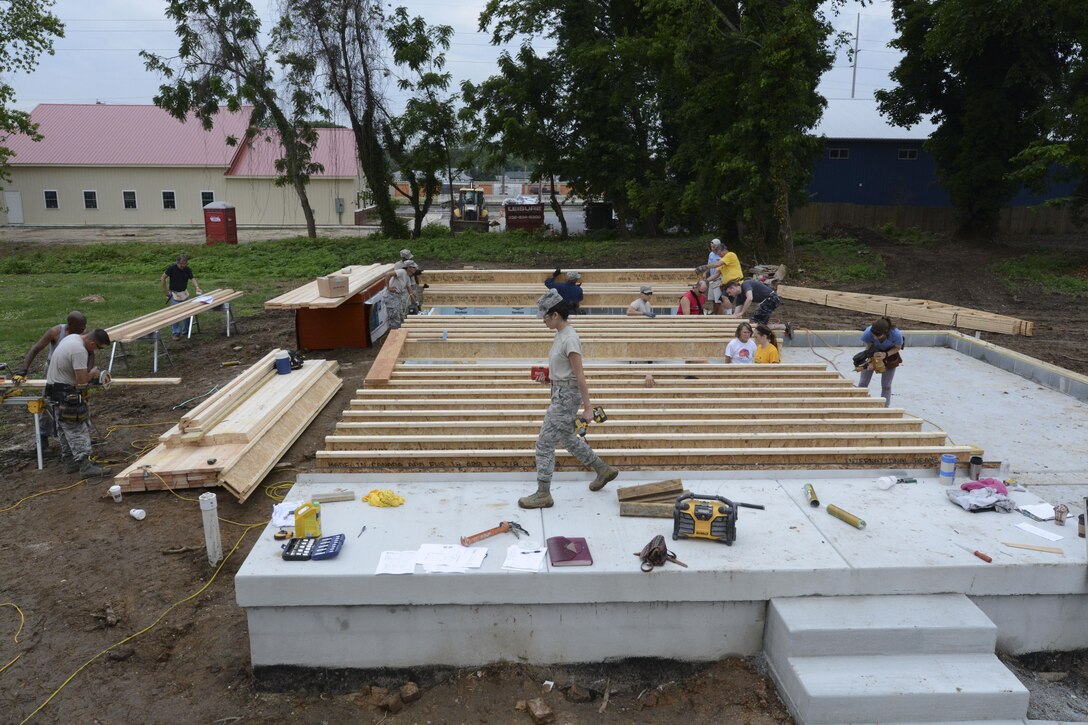 Members of the 512th Civil Engineer Squadron, Dover Air Force Base, Del, and local community members work on Habitat for Humanity houses in Dover, Del., June 6, 2015. As part of the Blitz Project, the reservists provided support to the site manager and home owners while utilizing their building skills. Five homes are scheduled to be built on a lot to assist with the rebuilding the community. (U.S. Air Force photo/Tech. Sgt. Mercedes Crossland)
