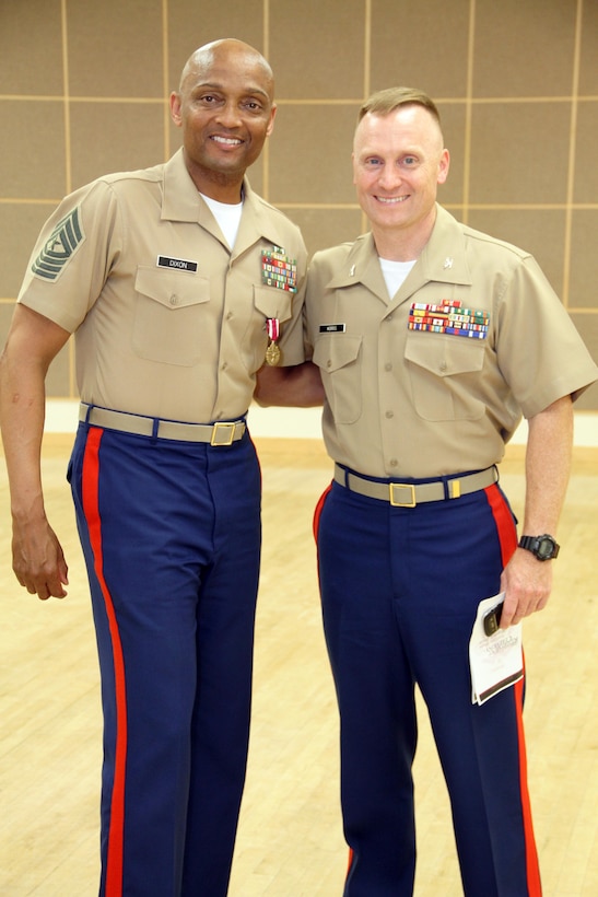 The Commanding Officer for the 9th Marine Corps District Recruiting Command, Colonel Morris, congratulated the Former Sergeant Major of Recruiting Station Des Moines at his retirement ceremony on May 29, 2015. SgtMaj Dixon retired from the Marine Corps after 30 years of faithful service .