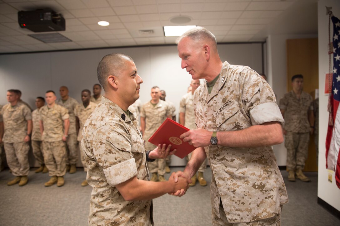 Marine Master Sergeant Christopher Lucio, Marine Corps Recruiting Information Support System (MCRISS) chief, receives the Meritorious Service Medal at Marine Corps Recruiting Command, Quantico, Va., June 15. The Meritorious Service Medal is presented to service members who have distinguished themselves by outstanding meritorious achievement or service to the United States. 