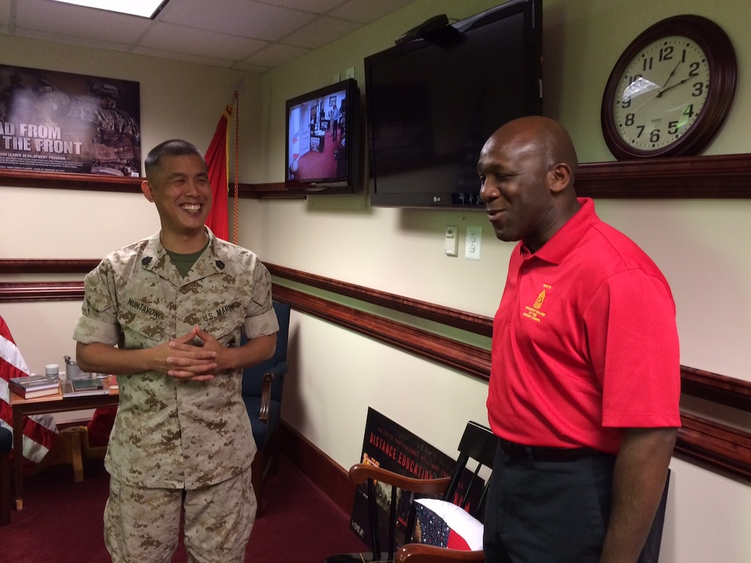 Gunnery Sgt. C. Nuntavong speaks with Sgt. Maj. Ronald L. Green following his reenlistment ceremony in the Office of the Sergeant Major of the Marine Corps at the Pentagon, Washington, D.C., June 18, 2015. (U.S. Marine Corps photo by Sgt. Maj. Anthony A. Spadaro)