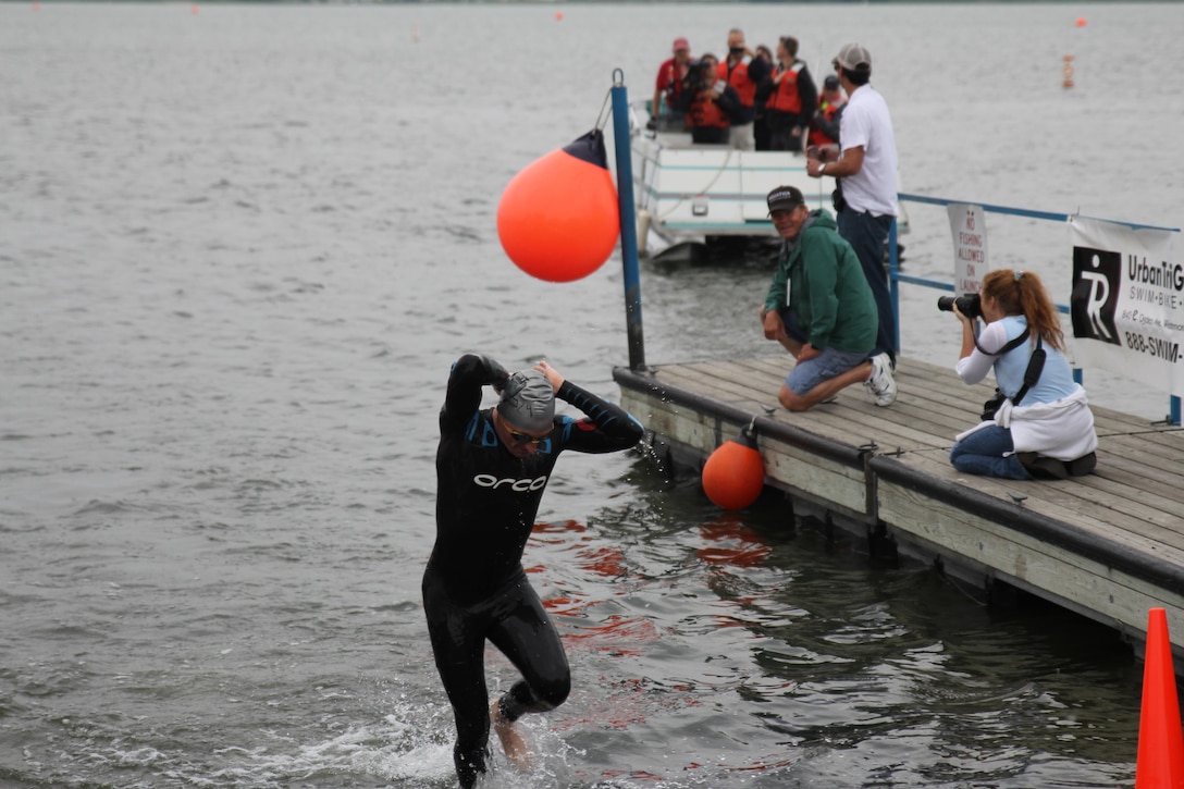 Navy Lt. Kyle Hooker of Whidbey Island, Wash. heads out of the water on his way to win the Armed Forces Triathlon Men's Championship with a time of !:51:24.