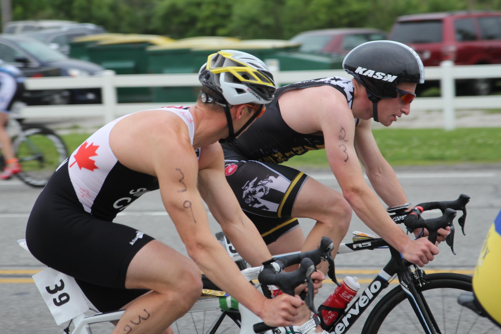 Canadian Armed Forces triathlete Dave Simpkin of Ottawa, Ontario rides along with Marine Corps Capt. Sean Sullivan of MCB Quantico, Va. During the 2015 Armed Forces Triathlon Championship at Wolf Lake in Hammond, Ind. held in conjunction with Leon's Triathlon on June 7, 2015. USA and Canada competed together in preparation of the CISM Military World Games held in Mungyeong, South Korea 1-12 October 2015.