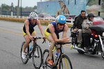 Navy Lieutenans Derek Oskutis (front) of NB San Diego, Calif. and 2015 Armed Forces Triathlon Champion Kyle Hooker of NAS Whidbey Island, Wash. take a commanding lead in the road race portion of the 2015 Armed Forces Triathlon Championship at Wolf Lake in Hammond, Ind. held in conjunction with Leon's Triathlon on June 7, 2015.