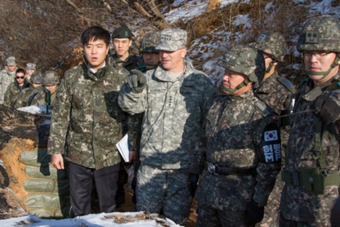 Gen. Curtis M. Scaparrotti, United Nation Command, Combined Forces Command, United States Forces Korea commander, and Command Sgt. Maj. John W. Troxell, UNC, CFC, USFK command sergeant major, join Republic of Korea Chairman of the Joint Chiefs of Staff Adm. Choi  Yoon-Hee on a visit with soldiers of the 25th Infantry Division at Sang-Seung observation point, South Korea, Dec. 23, 2013. (U.S. Army photo by Sgt. Brian Gibbons)
