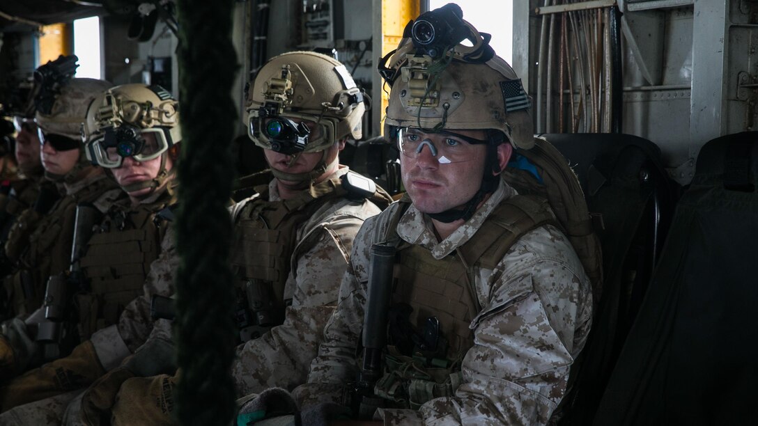U.S. Marine Sgt. Zach Ray ,right, prepares to fast-rope out of a CH-53E Super Stallion onto the flight deck of the USS Essex (LHD 2) at sea in the Indian Ocean, June 17, 2015. Ray is a member of the 15th Marine Expeditionary Unit’s Maritime Raid Force. These Marines practice fast-roping from different platforms to ensure they are confident in any aircraft they may use on a mission. 
