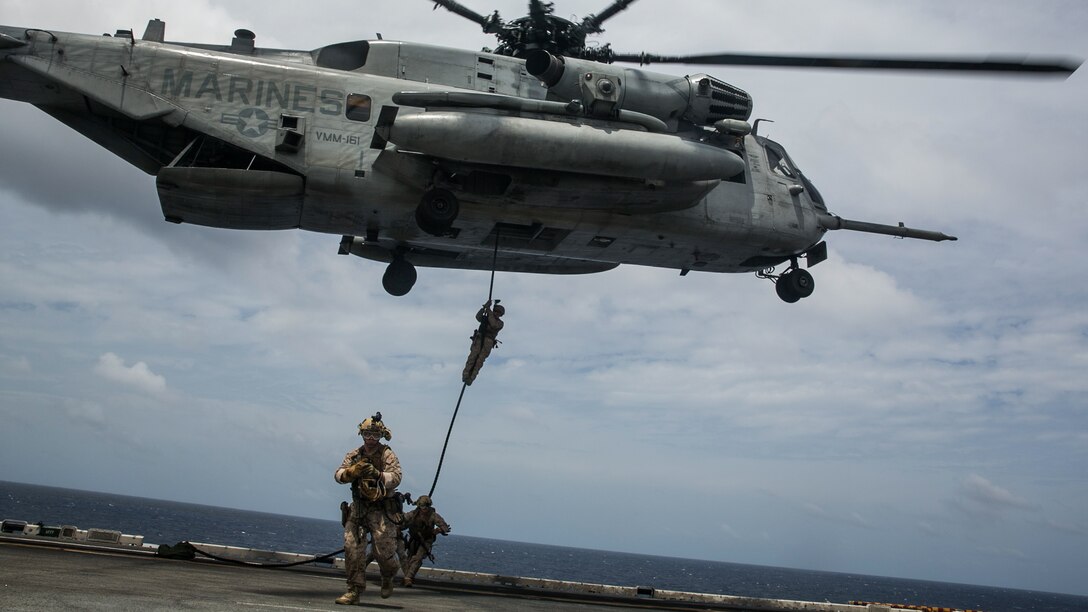 U.S. Marines with the 15th Marine Expeditionary Unit’s Maritime Raid Force fast-rope out of a CH-53E Super Stallion onto the flight deck of the USS Essex (LHD 2) at sea in the Indian Ocean, June 17, 2015. These Marines practice fast-roping from different platforms to ensure they are confident in any aircraft they may use on a mission. 