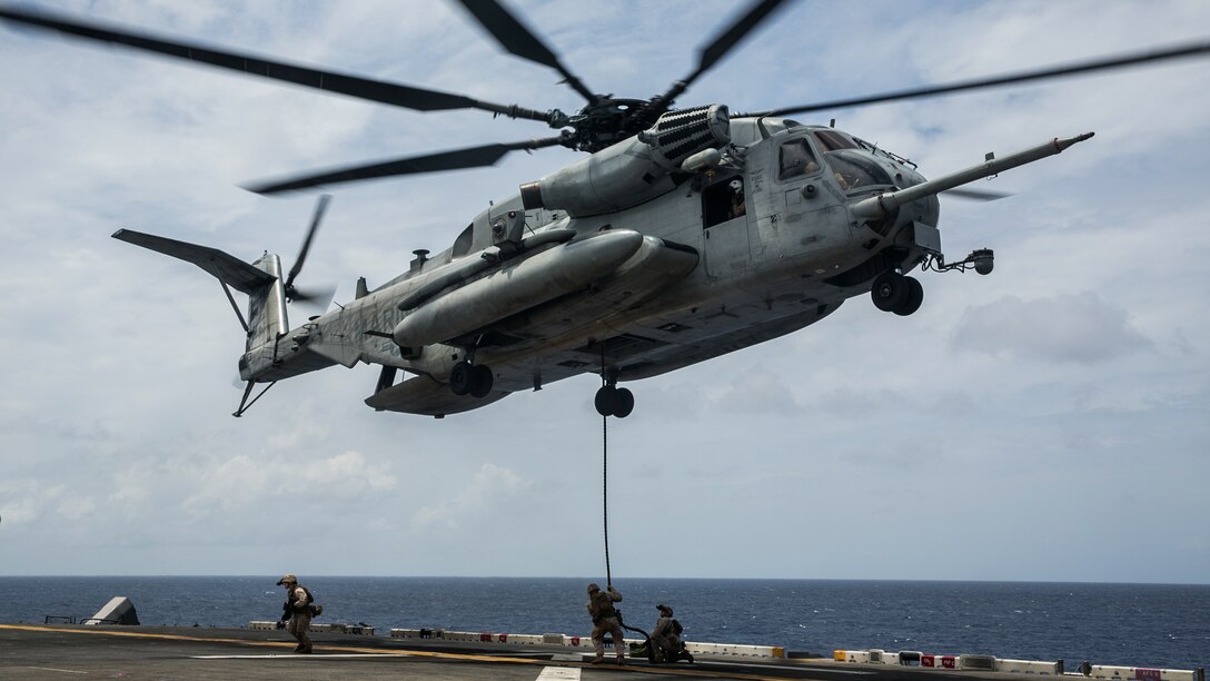 U.S. Marines with the 15th Marine Expeditionary Unit’s Maritime Raid Force fast-rope out of a CH-53E Super Stallion onto the flight deck of the USS Essex (LHD 2) at sea in the Indian Ocean, June 17, 2015. Fast-roping from a helicopter onto a moving vessel is an essential skill for the MRF during visit, board, search, and seizure missions. 