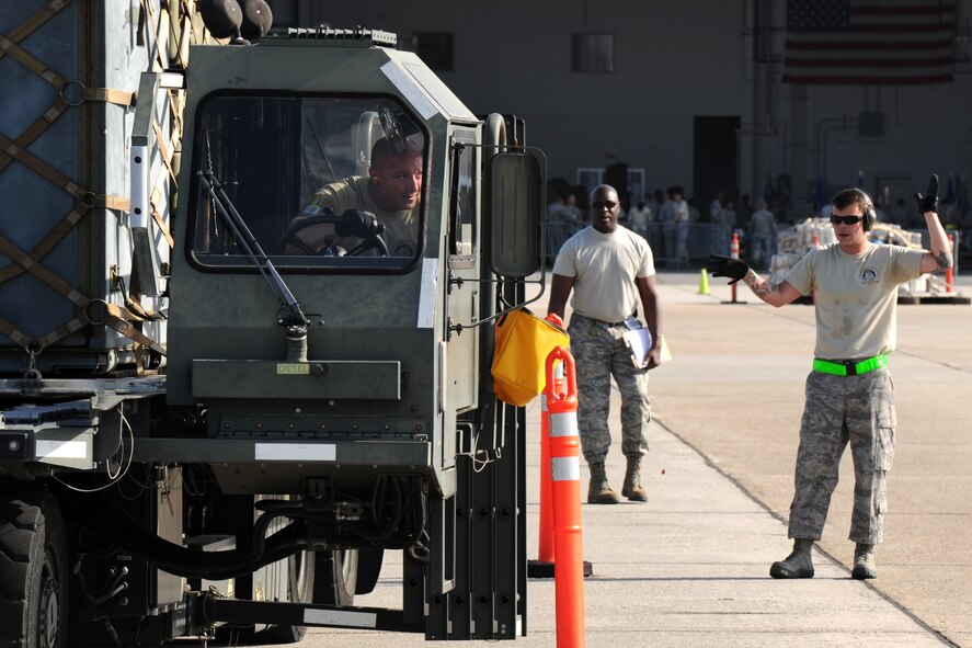 U.S. Air Force Staff Sgt. Brady Frasier, left, is guided by Tech. Sgt. Steven Digby, both assigned to the 71st Aerial Port Squadron, as a driver in the 25K Halverson driving and loading course during the Port Dawg Challenge at Dobbins Air Reserve Base, Ga., June 16, 2015. The Port Dawg Challenge was created to enhance and maintain the camaraderie, esprit de corps and prestige of aerial port Airmen while promoting professionalism, leadership, training and communication between "Port Dawgs." (U.S. Air Force photo by Tech. Sgt. Stephen D. Schester/Released)