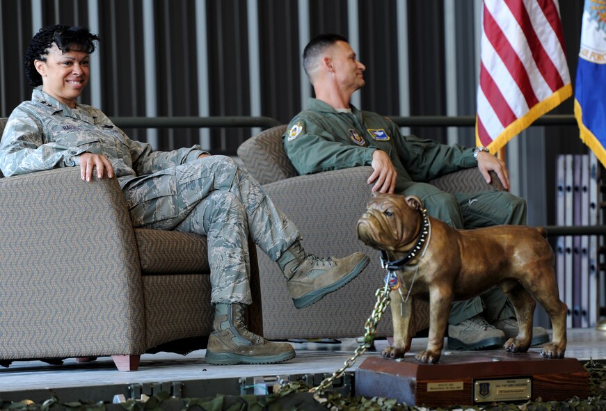U.S. Air Force Maj. Gen. Stayce Harris, 22nd Air Force commander, and the 94th Airlift Wing commander, U.S. Air Force Col. Brett Clark, sit on stage near a full-size bronze sculpture of a bulldog, the trophy for the "Top Dawg," at the opening ceremony of the Port Dawg Challenge at Dobbins Air Reserve Base, Ga., June 16, 2015. The Port Dawg Challenge was created to enhance and maintain the camaraderie, esprit de corps and prestige of aerial port Airmen while promoting professionalism, leadership, training and communication between "Port Dawgs." (U.S. Air Force photo by Tech. Sgt. Stephen D. Schester/Released)