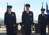 Col. Randy Huiss, 15th Wing commander, Col. Michael Merritt, 15th Operations Group commander and Col. Charles Velino, 15th Operations Group In-coming commander, stand at attention during the 15th Operations Group change of command ceremony on Joint Base Pearl Harbor-Hickam, Hawaii, June 18, 2015. During the ceremony, Merritt was presented the Legion of Merit for his outstanding service and accomplishments as commander to the 15 OG. (U.S. Air Force Photo by Tech Sgt. Terri Paden/Released)