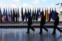 Col. Randy Huiss, 15th Wing commander, Col. Michael Merritt, 15th Operations Group commander and Col. Charles Velino, 15th Operations Group In-coming commander, cross hanger 19 during the 15th Operations Group change of command ceremony on Joint Base Pearl Harbor-Hickam, Hawaii, June 18, 2015. Velino, who assumed command of the 15th OG during the ceremony, is a command pilot with over 550 combat hours and 3,500 hours in the C-17A Globemaster III,T-1 and T-37 aircraft. (U.S. Air Force Photo by Tech Sgt. Terri Paden/Released)