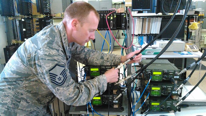 U.S. Air Force Master Sgt. John Sperling, 354th Communications Squadron NCO in charge of radio frequency transmissions, connects an ultra-high frequency radio cable to the outside antenna in order to relay exercise communications back to Joint Base Elmendorf-Richardson. NORTHERN EDGE 2015 is Alaska's premier joint training exercise designed to practice operations, techniques and procedures as well as enhance interoperability among the services. (Courtesy photo) 