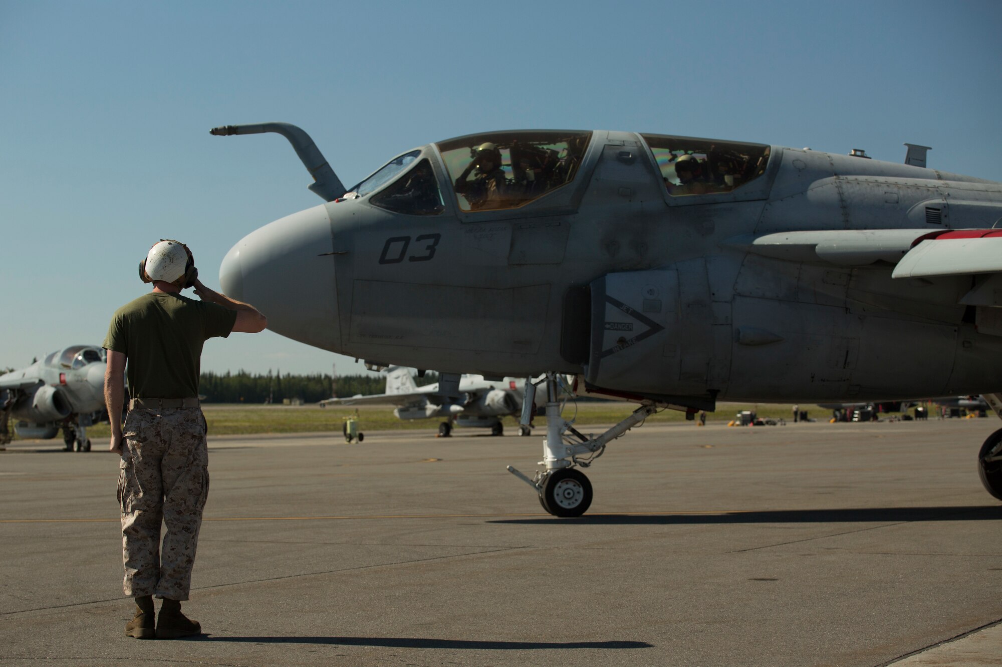 Lance Cpl. Gerrit B. Gribble, from Phoenix, Arizona, salutes the pilot of an EA-6B Prowler before it takes off during Exercise Northern Edge 2015 June 15 at Eielson Air Force Base, Alaska. NE15 is Alaska’s premier joint training exercise designed to practice operations, techniques and procedures as well as enhance interoperability among the services. Thousands of participants from all of the services, airmen, soldiers, sailors Marines and Coast Guardsmen from active duty, reserve and National Guard Units are involved. Gribble is an aircraft mechanic with Marine Tactical Electronic Warfare Squadron 2, Marine Aircraft Group 14, 2nd Marine Aircraft Wing, II Marine Expeditionary Force. (U.S. Marine Corps Photo by Cpl. Thor J. Larson/Released)