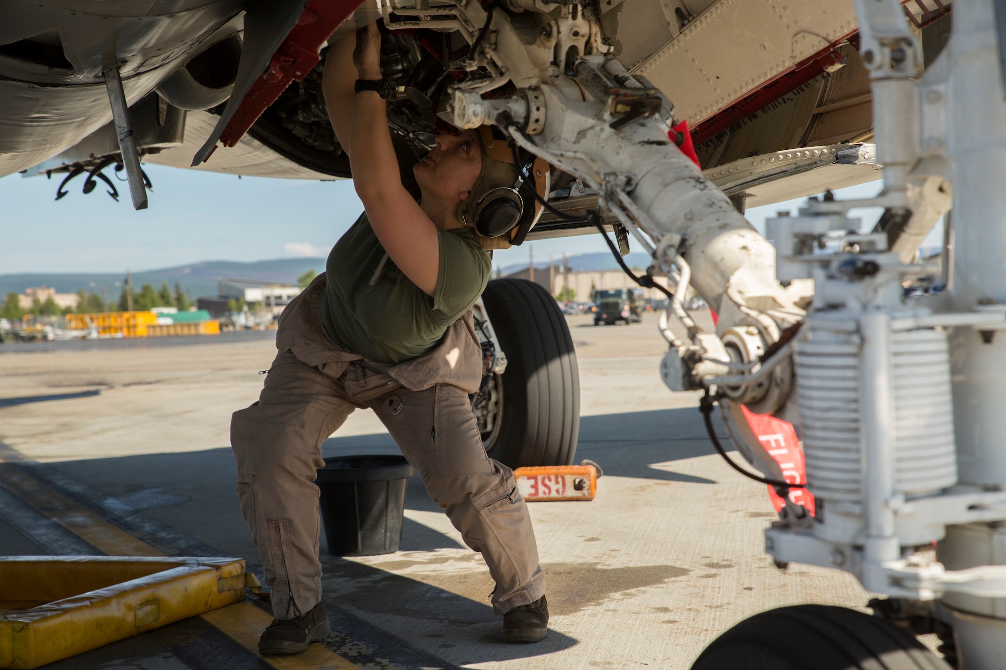 Lance Cpl. Jessica Kerr, from St. Louis, Missouri, inspects an EA-6B Prowler during Exercise Northern Edge 2015, June 15 at Eielson Air Force Base, Alaska. The Prowler is an electronic warfare aircraft used to jam radar signals making other military aircraft invisible to radar. NE15 is Alaska’s premier joint training exercise designed to practice operations, techniques and procedures as well as enhance interoperability among the services. Thousands of participants from all of the services, airmen, soldiers, sailors Marines and Coast Guardsmen from active duty, reserve and National Guard Units are involved. Kerr is a plane captain with Marine Tactical Electronic Warfare Squadron 2, Marine Aircraft Group 14, 2nd Marine Aircraft Wing, II Marine Expeditionary Force. (U.S. Marine Corps Photo by Cpl. Thor J. Larson/Released)