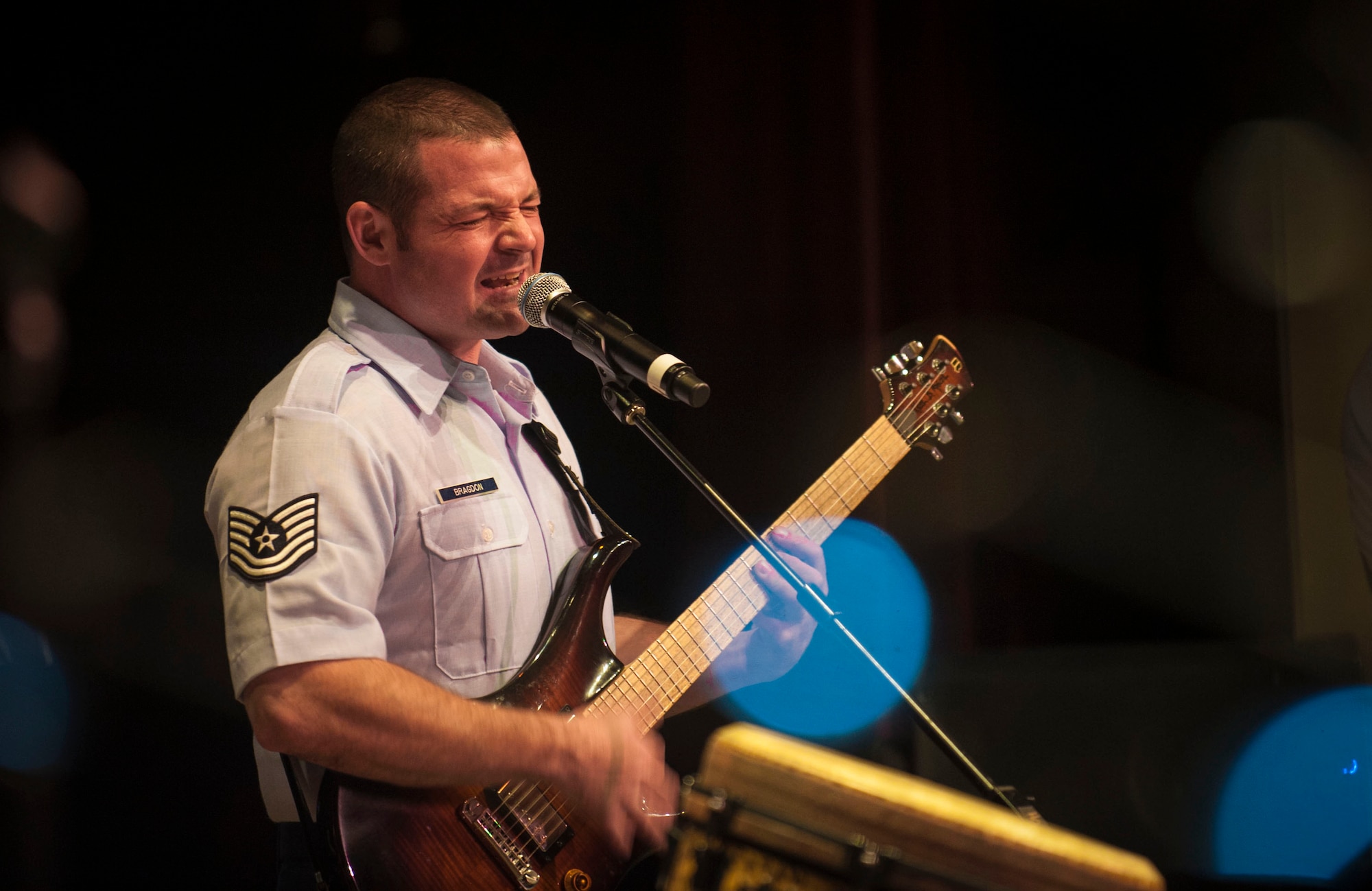 Tech. Sgt. Dan Bragdon, U.S. Air Force Heartland of America Band Vortex guitarist, performs with his band in Nelson Hall, at Minot State University, Minot N.D., June 16, 2015. The show was dedicated to local Vietnam veterans and featured songs from 1965 through 1975. (U.S. Air Force photo/Senior Airman Stephanie Morris)