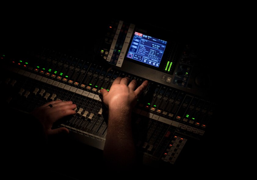 A sound technician for the U.S. Air Force Heartland of America Band Vortex adjusts audio levels during a concert in Nelson Hall, at Minot State University, Minot N.D., June 16, 2015. The set list included such hits as “Danny Boy”, “The Green Beret” and a tuba solo of “Blue Bells of Scotland” by Detroit, Michigan native, Master Sgt. Alex Serwatowski. (U.S. Air Force photo/Senior Airman Stephanie Morris)