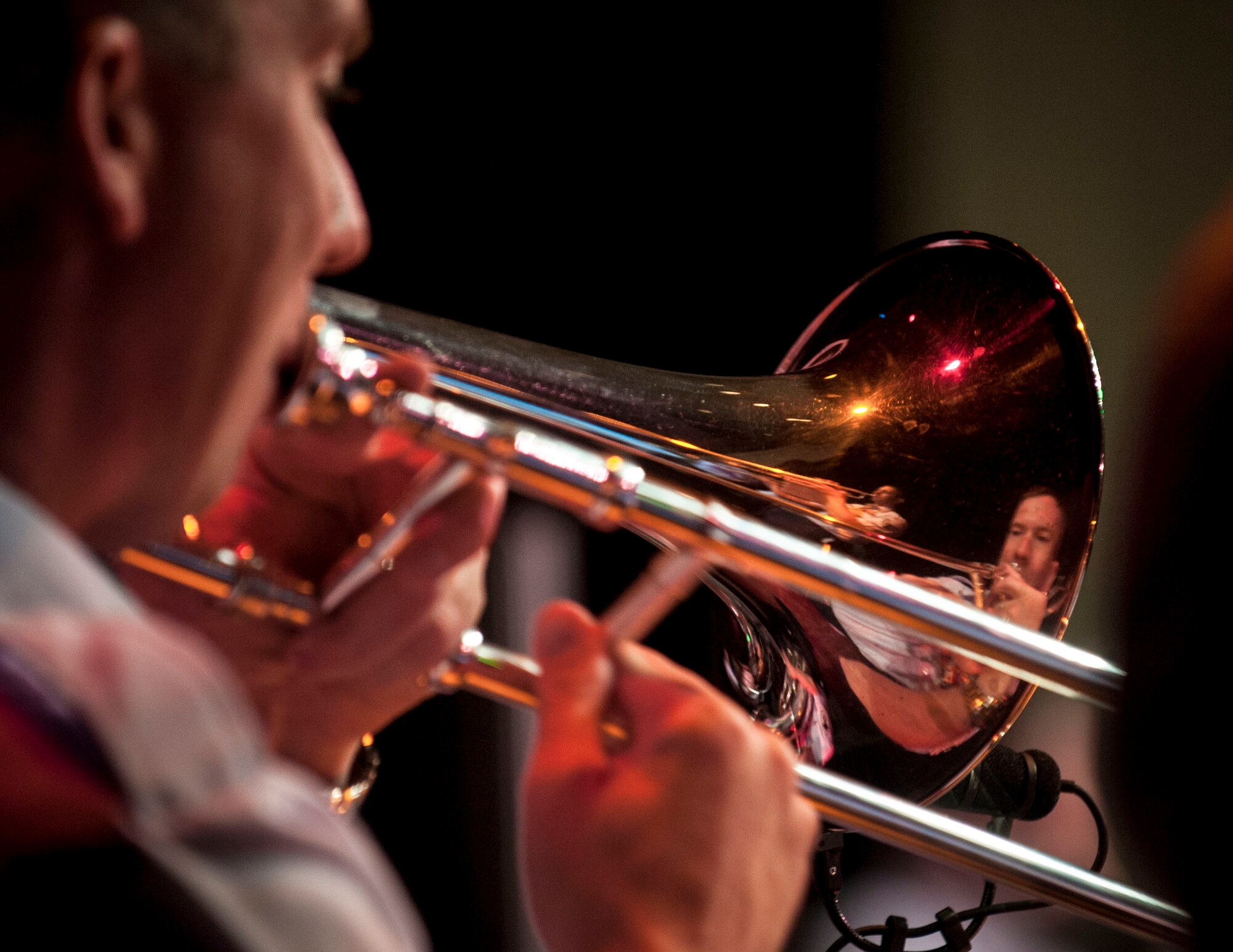 Tech. Sgt. Ben Kadow, U.S. Air Force Heartland of America Band Vortex trombone player, performs with his band during a concert in Nelson Hall, at Minot State University, Minot N.D., June 16, 2015. Kadow is a native of Perham, Minnesota and was the only trombone player at the concert. (U.S. Air Force photo/Senior Airman Stephanie Morris)